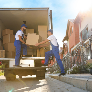 Two men are loading boxes into a truck.