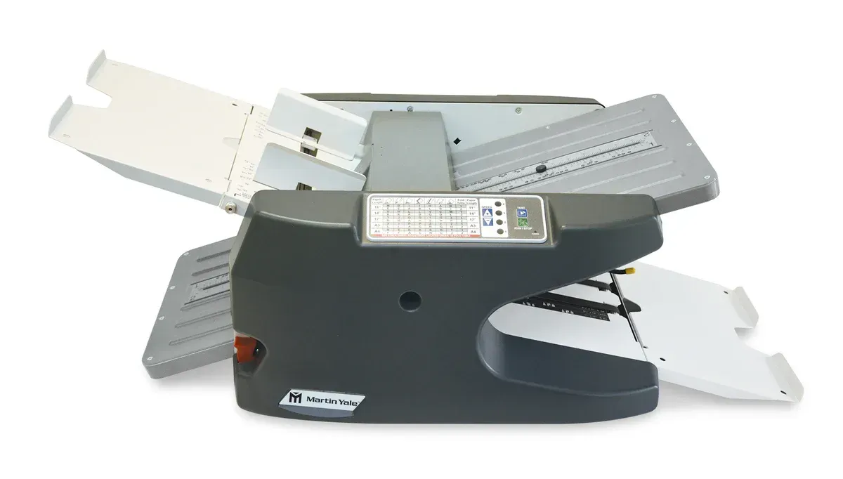 A black and gray machine is sitting on a white surface.