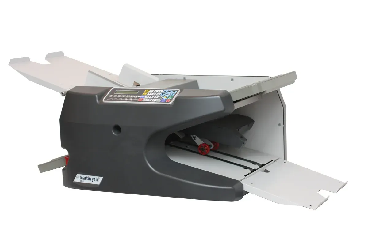 A black and white printer is sitting on a white surface.