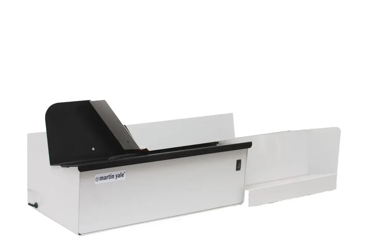 A white box with a black lid is sitting on a white surface.