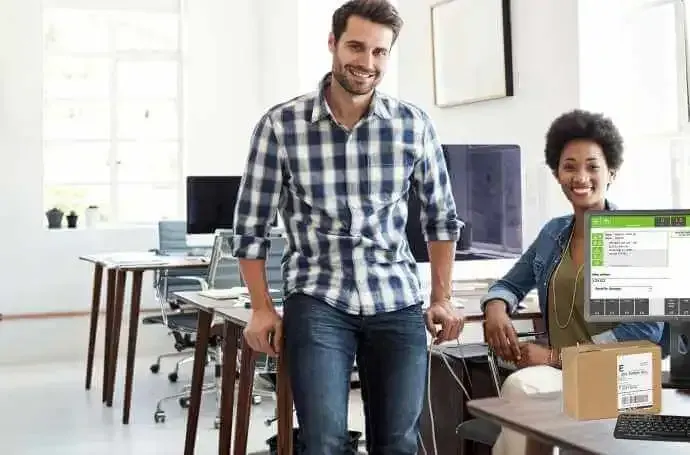 A man and a woman are standing next to each other in an office.