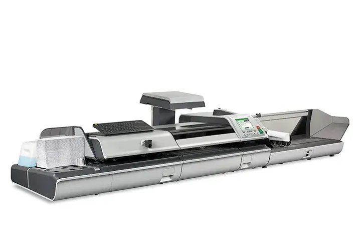 A large gray and black machine is sitting on a white surface.