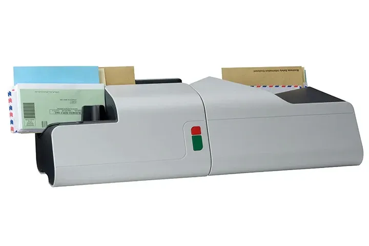 A machine is sitting on a table with envelopes in it.
