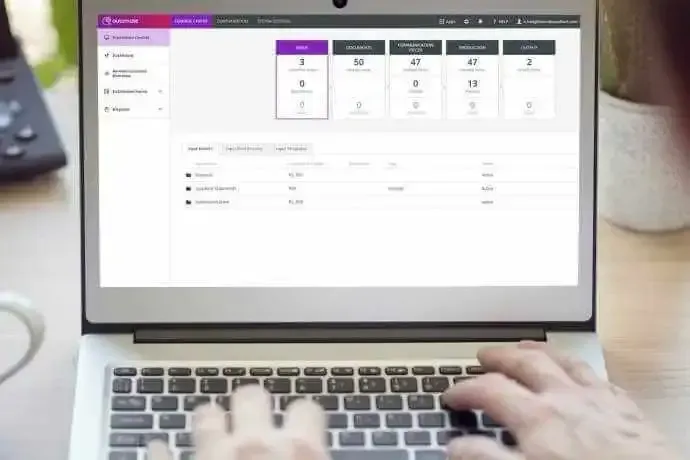 A person is typing on a laptop computer.