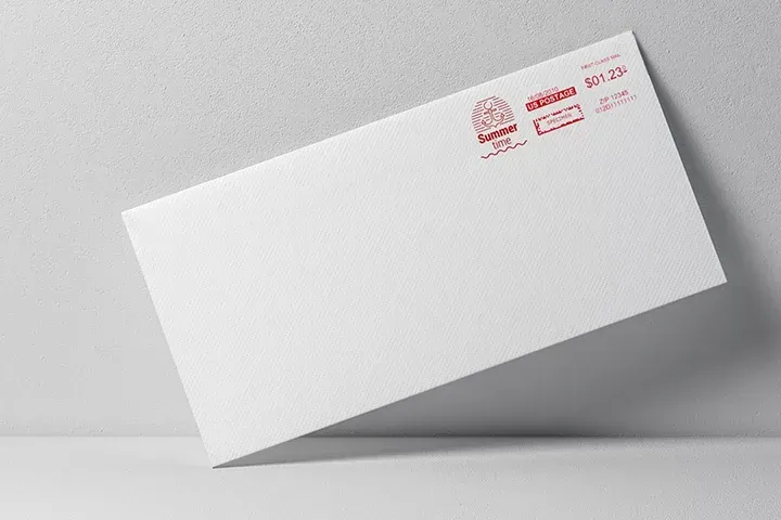 A white envelope is sitting on a white surface.