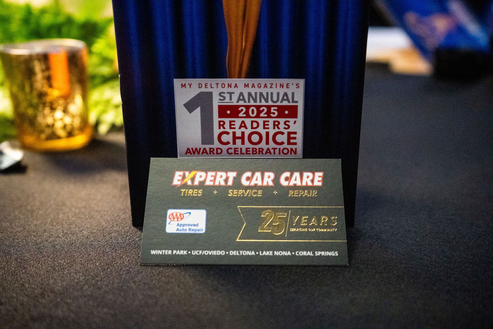 Award plaque for 2025 Stannual Choice Award on a table, with blurred glass and blue chair in background