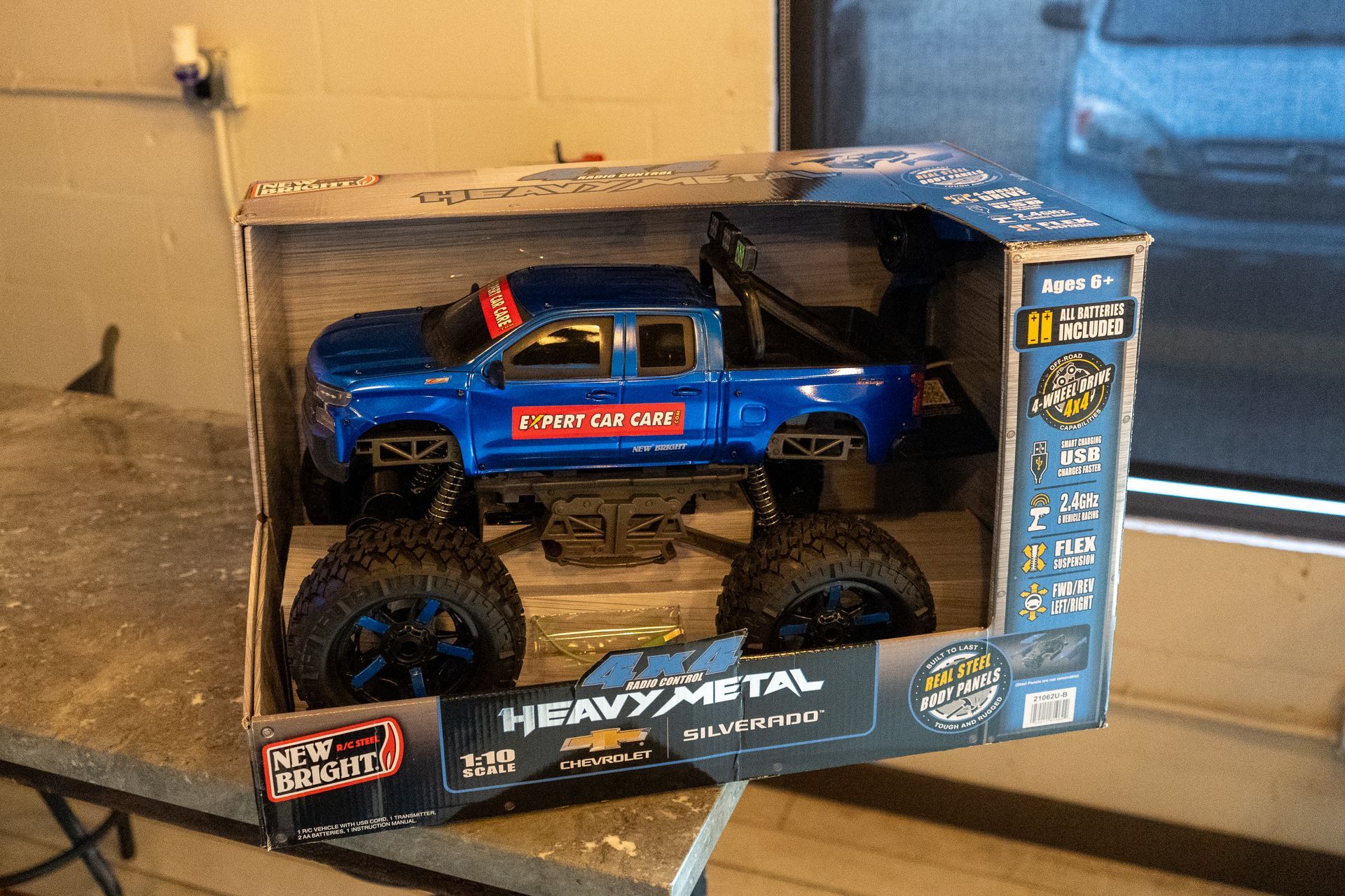 Blue remote-control monster truck in a boxed toy package on a tabletop