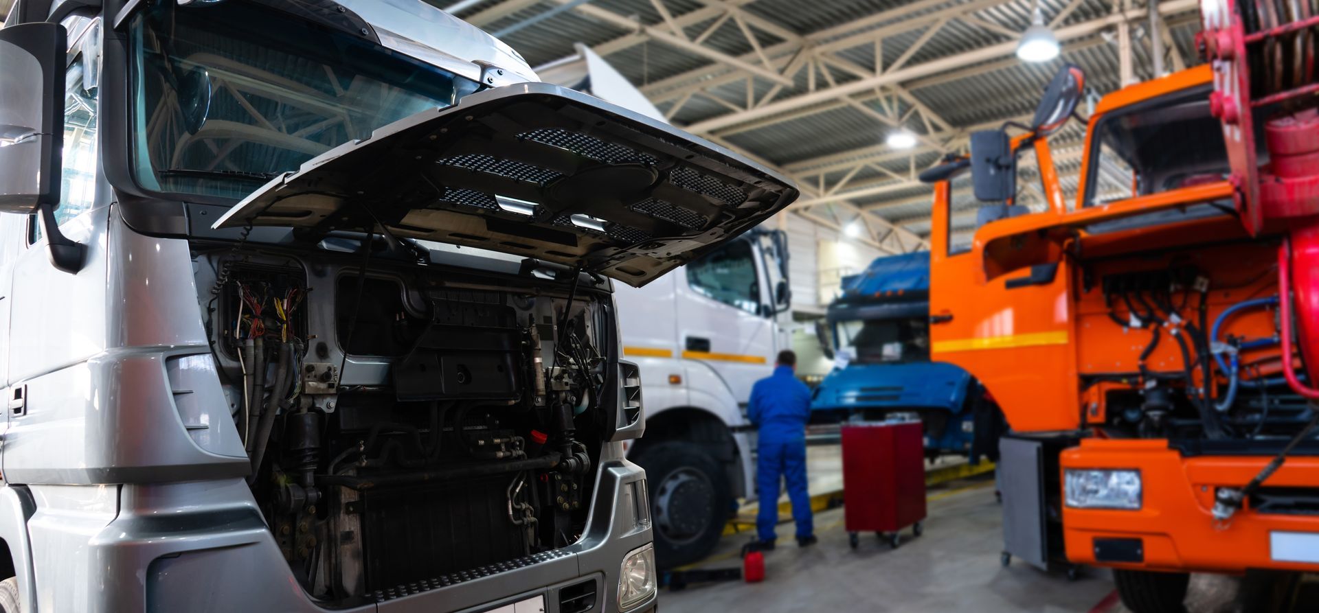 Medium duty truck with hood open being serviced in a commercial vehicle repair shop Medium duty truck with hood open being serviced in a commercial vehicle repair shop