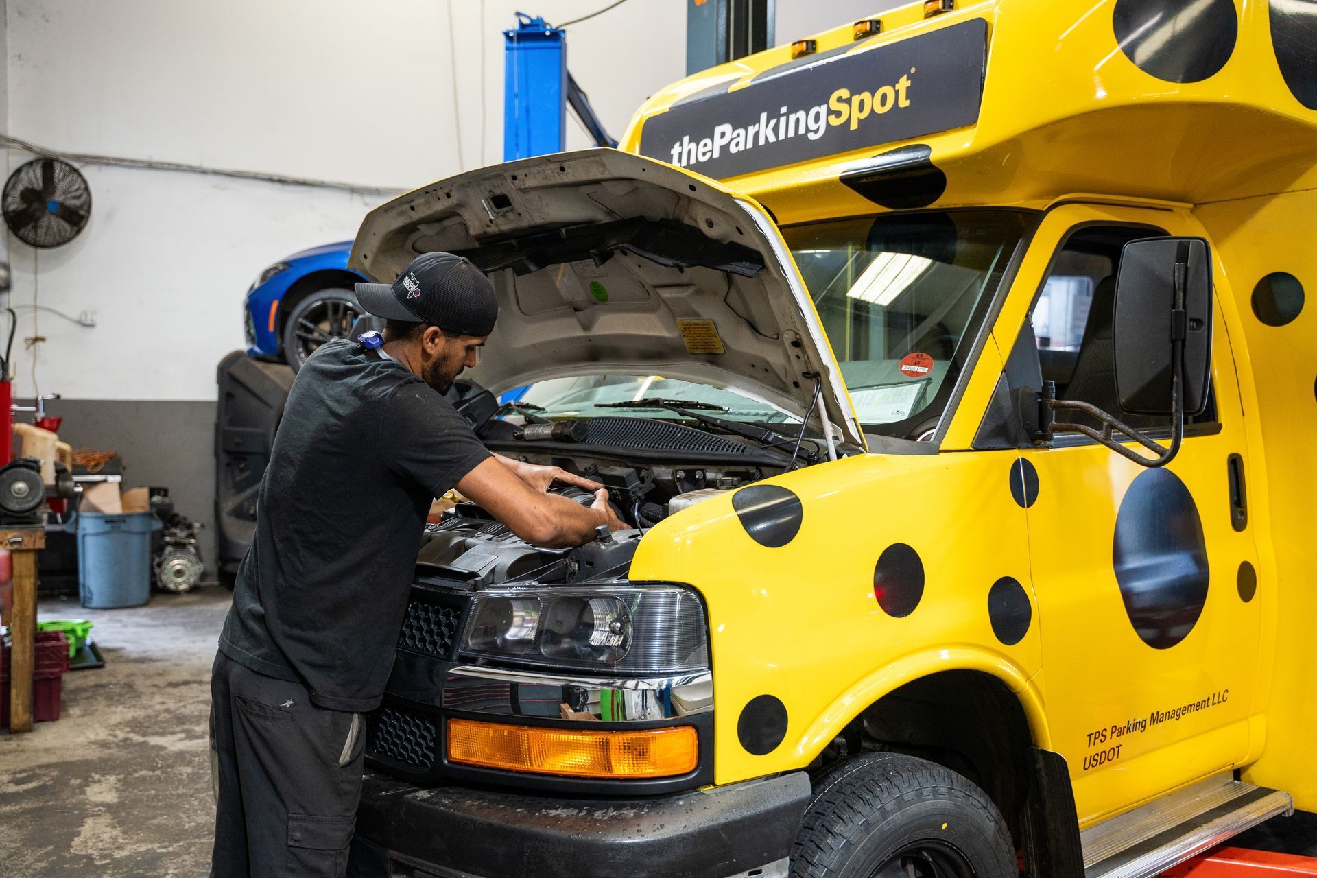 Mechanic repairing the engine of a branded fleet van