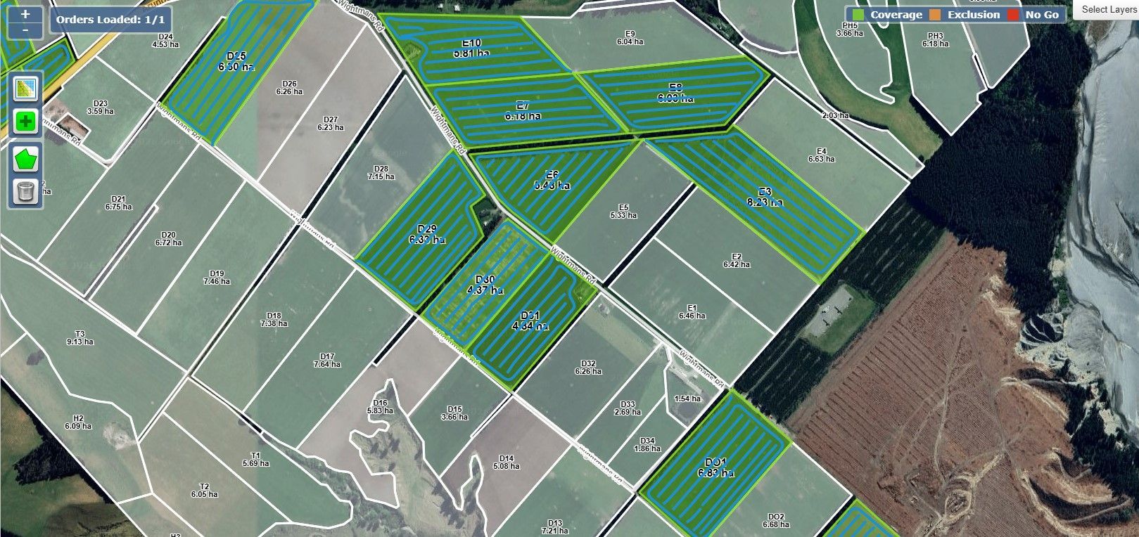 Satellite map with green striped highlighted zones over fields beside a rocky coastline.