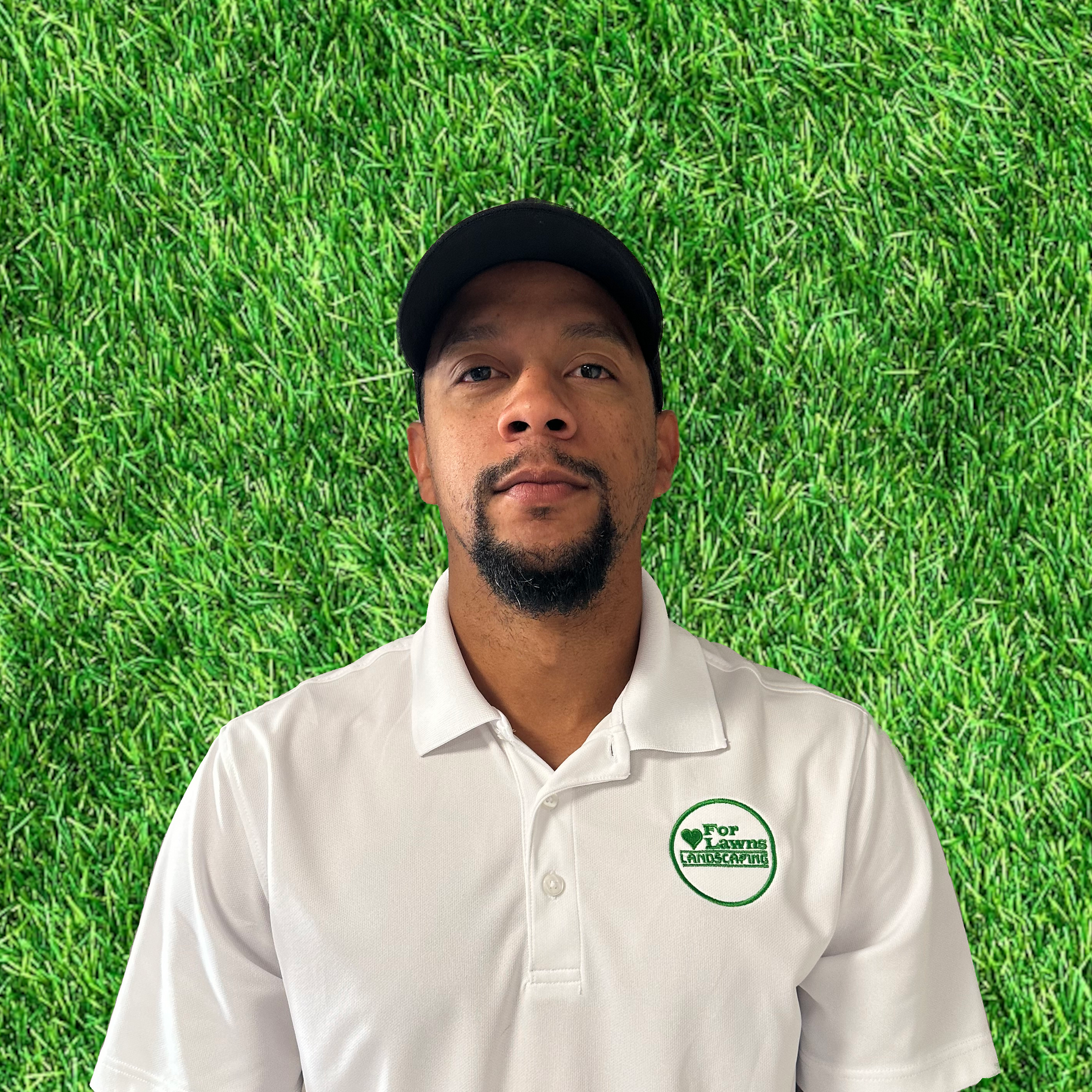 A man with a beard is wearing a white shirt and a black hat.