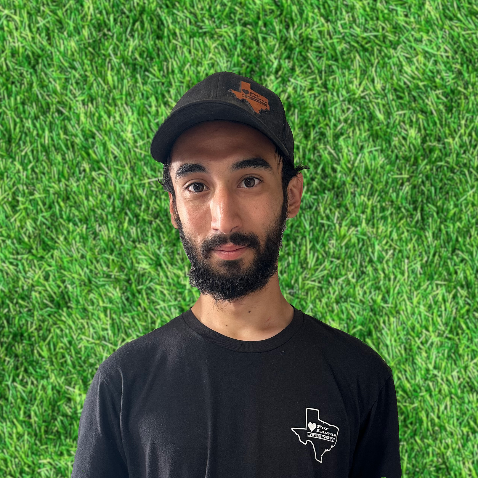 A man with a beard is wearing a hat and a black shirt.