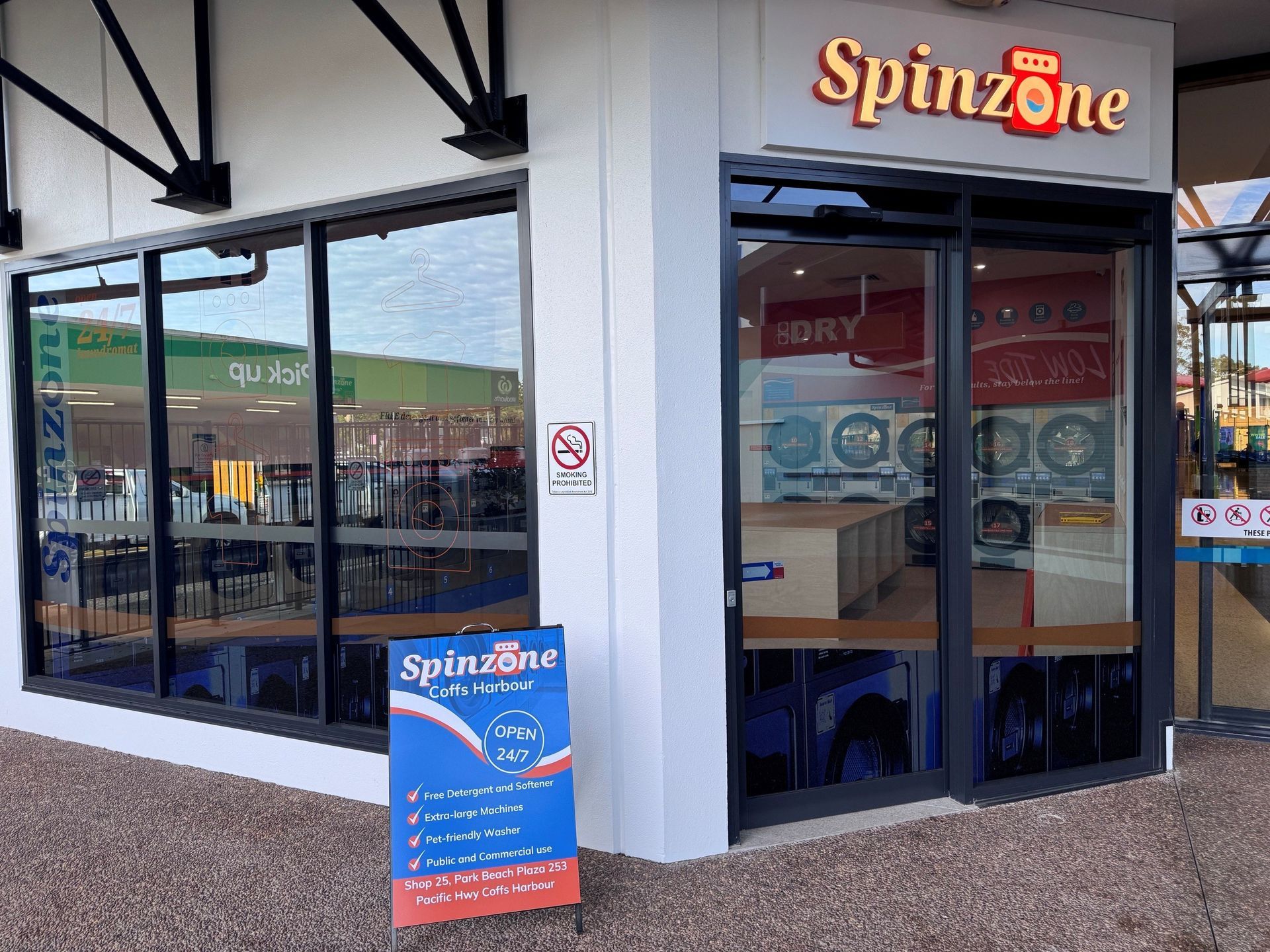 Spinzone storefront with glass doors, windows, and a sidewalk sign outside.