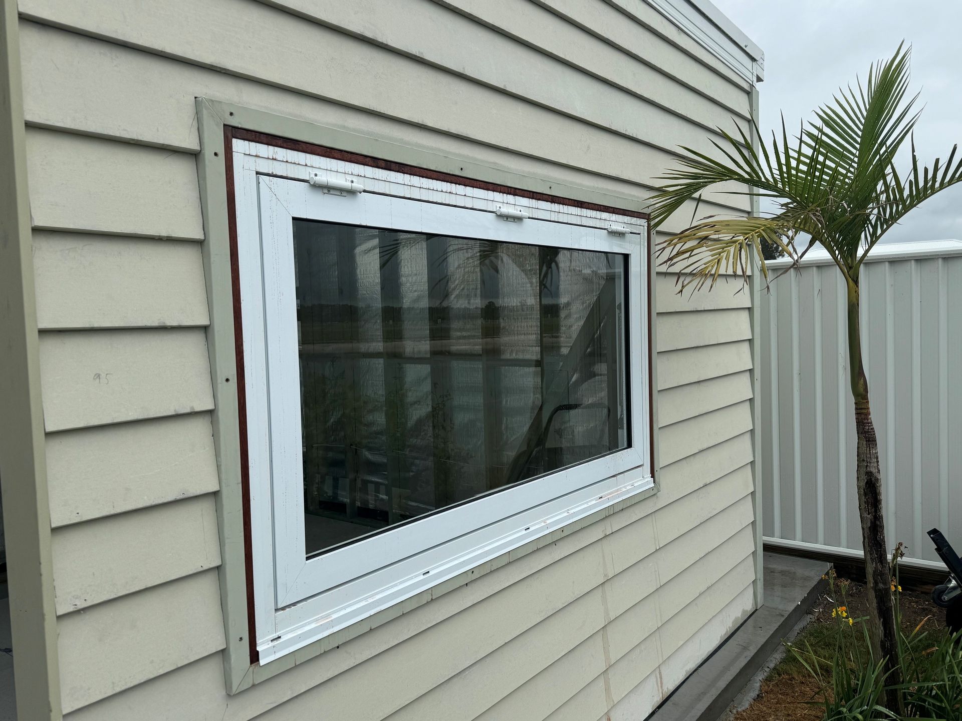 Covered walkway with large glass doors overlooking a grassy field