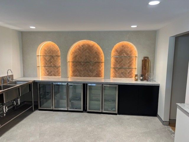 Modern office reception area with glass partitions, white desks, and a notebook on the counter