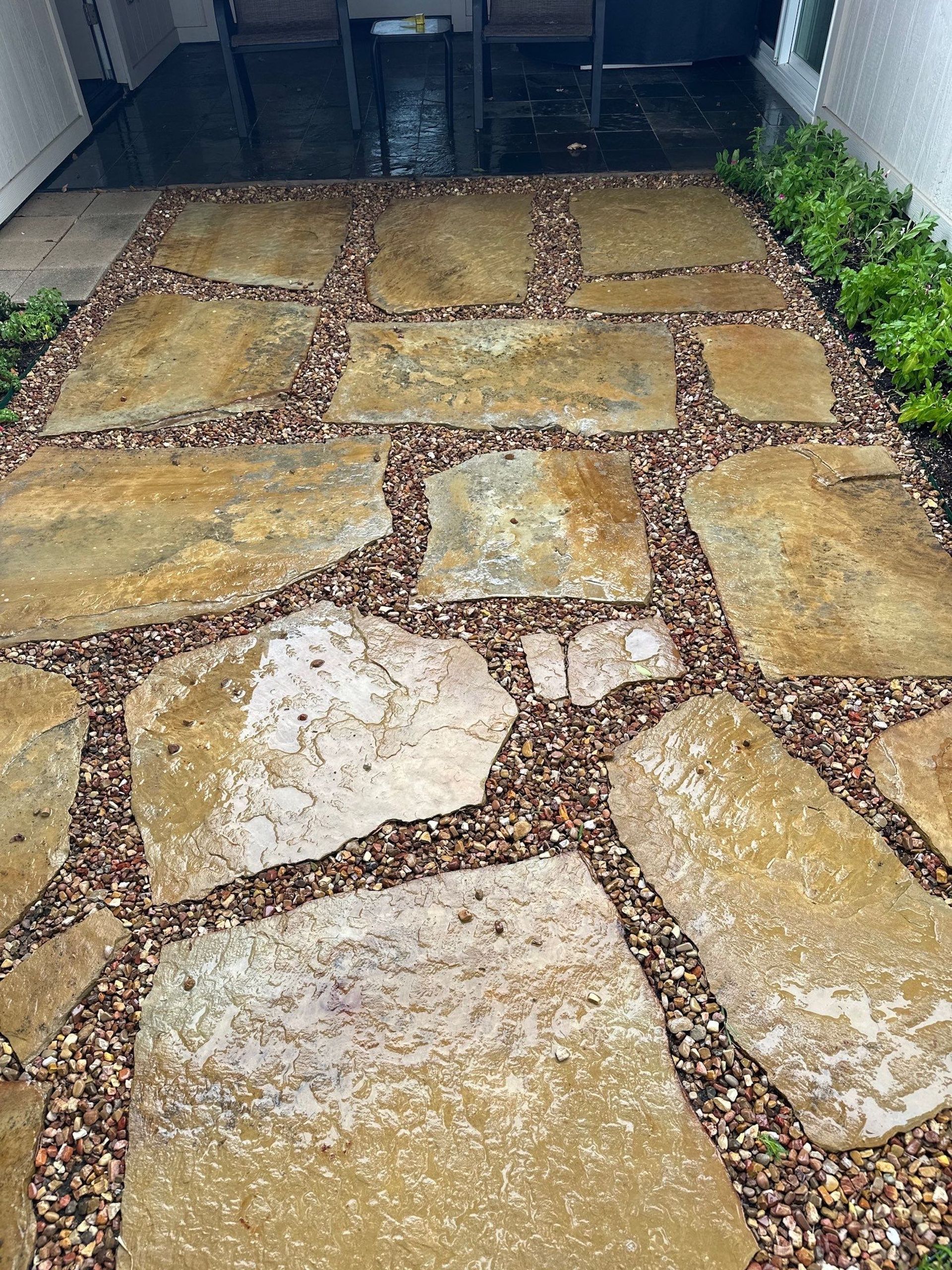 A walkway made of rocks and gravel in a yard.