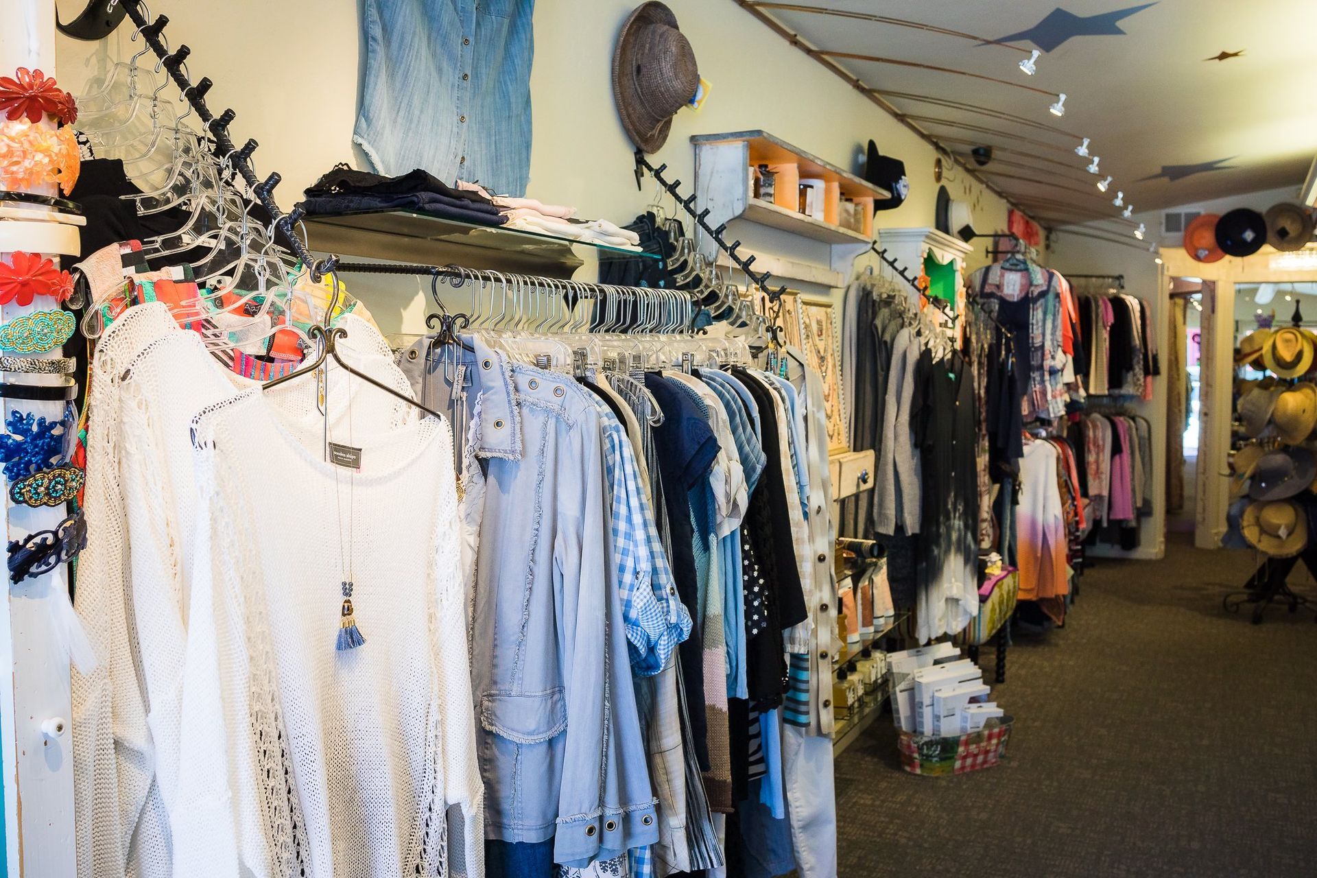 Clothing store interior with racks of clothing.