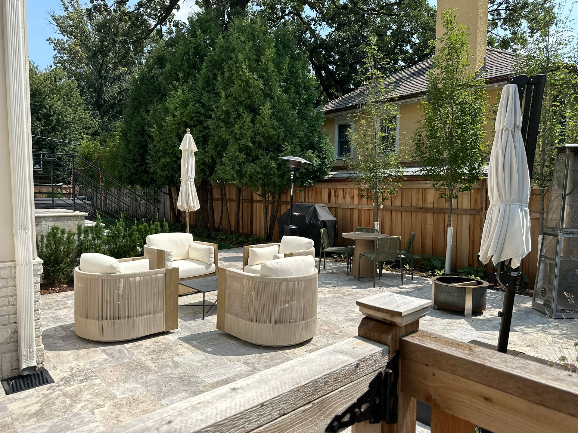 Outdoor living area small Minneapolis backyard with natural stone patio new fence plantings cozy seating 