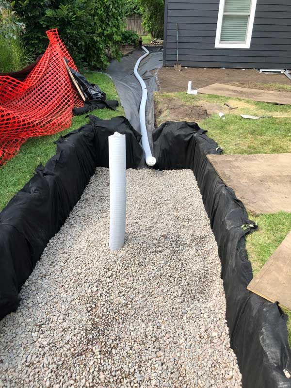 dry well landscaping drainage feature being installed