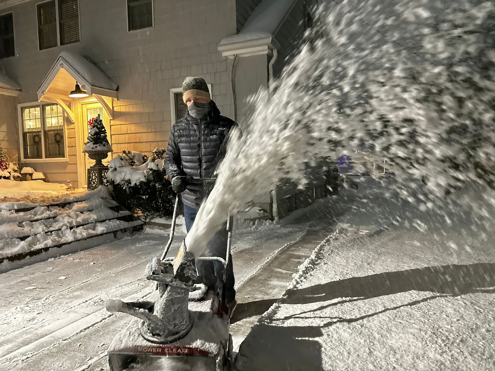 Guy snow blowing a driveway for a house in St. Louis Park MN 