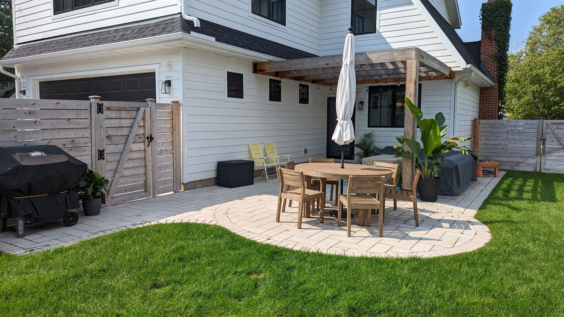 New paver patio with cedar pergola designed and installed by KG Landscape in Edina MN 