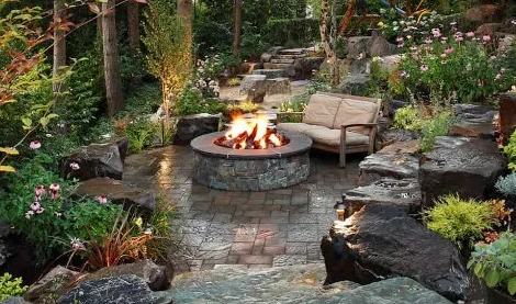 A patio with a fire pit and a sectional couch
