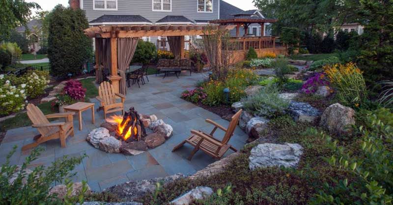 There is a fire pit in the middle of the patio.