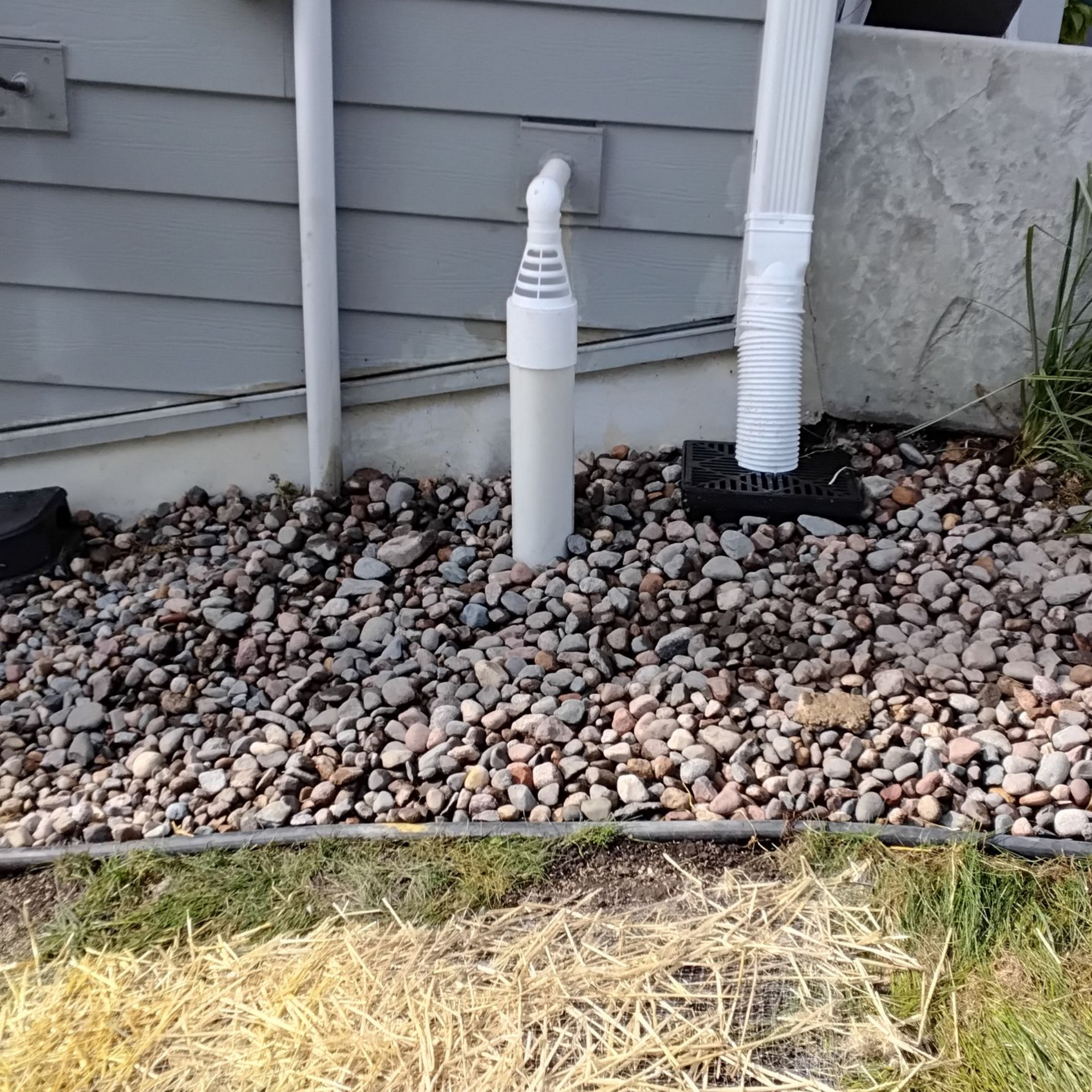 Underground downspout drainage system with sump pump drainage tied in at a home in Plymouth MN