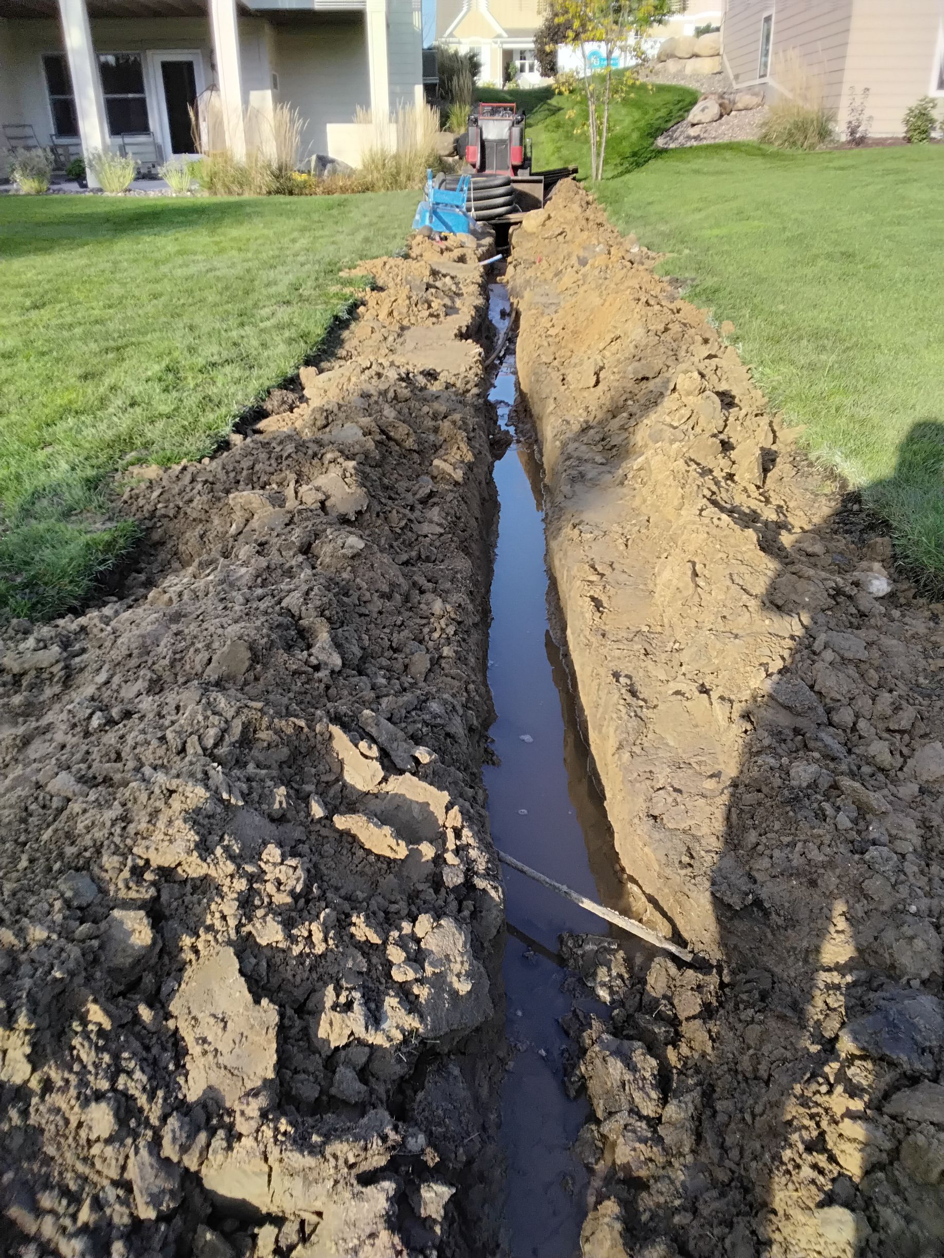 French drain trench already draining water during installation