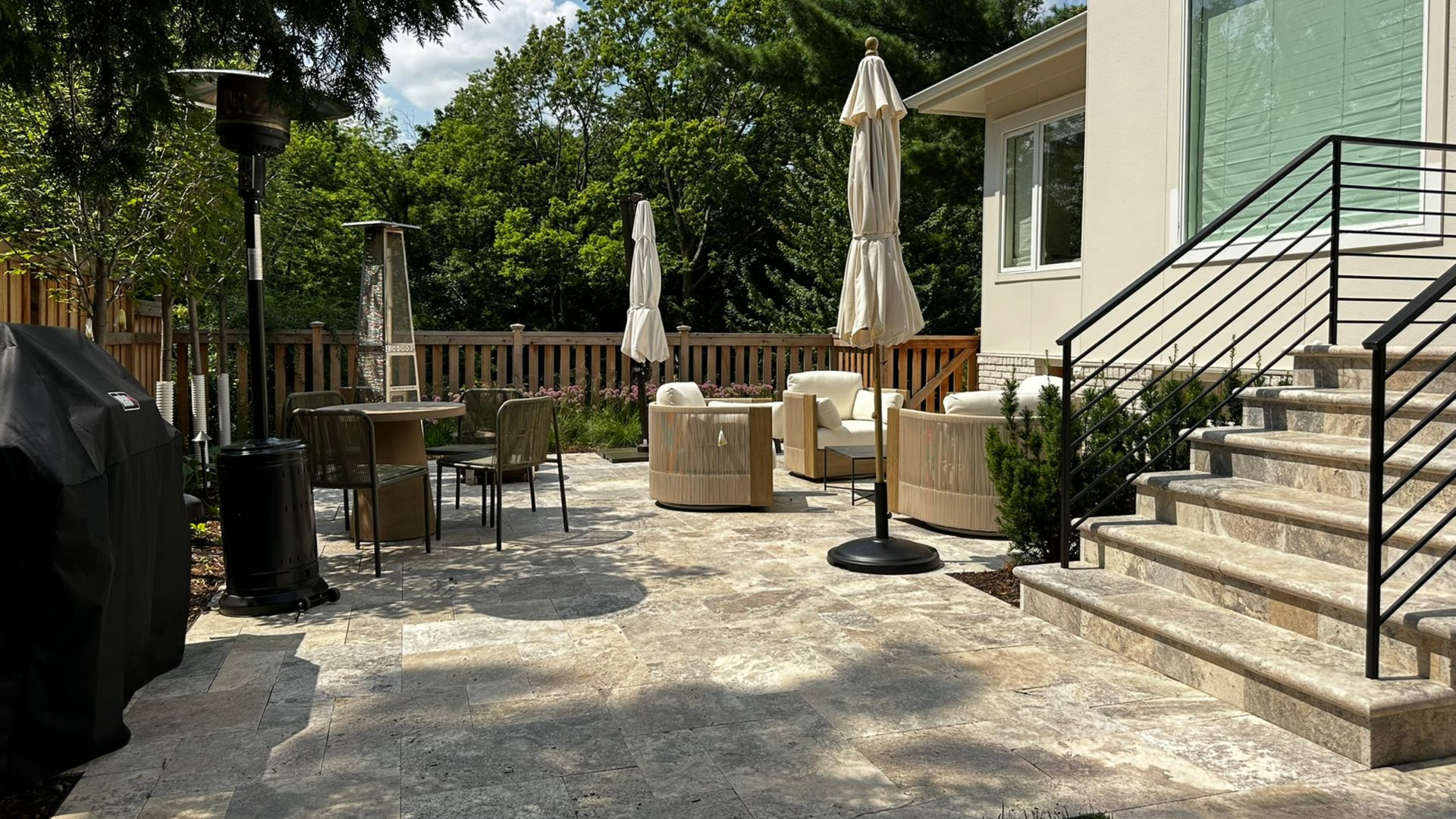 natural stone patio new steps and landing with nice furniture and plantings in Minneapolis