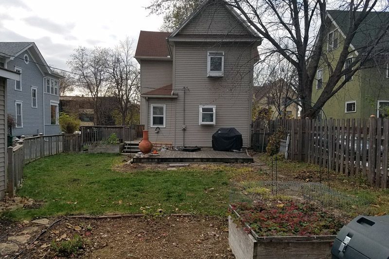 Whittier backyard in Minneapolis before the project, with patchy grass and bare soil
