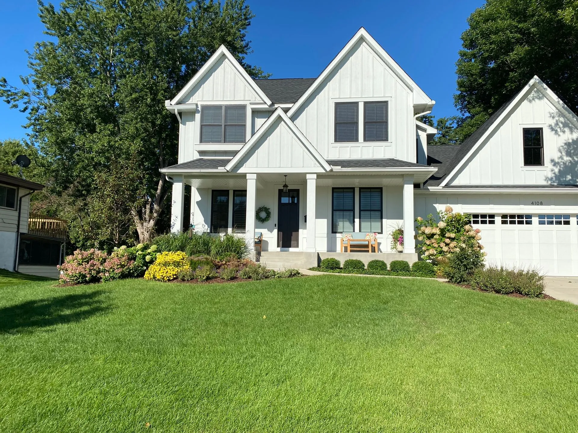 Front yard landscaping with seasonal color, ornamental grasses, and evergreen texture in Edina MN