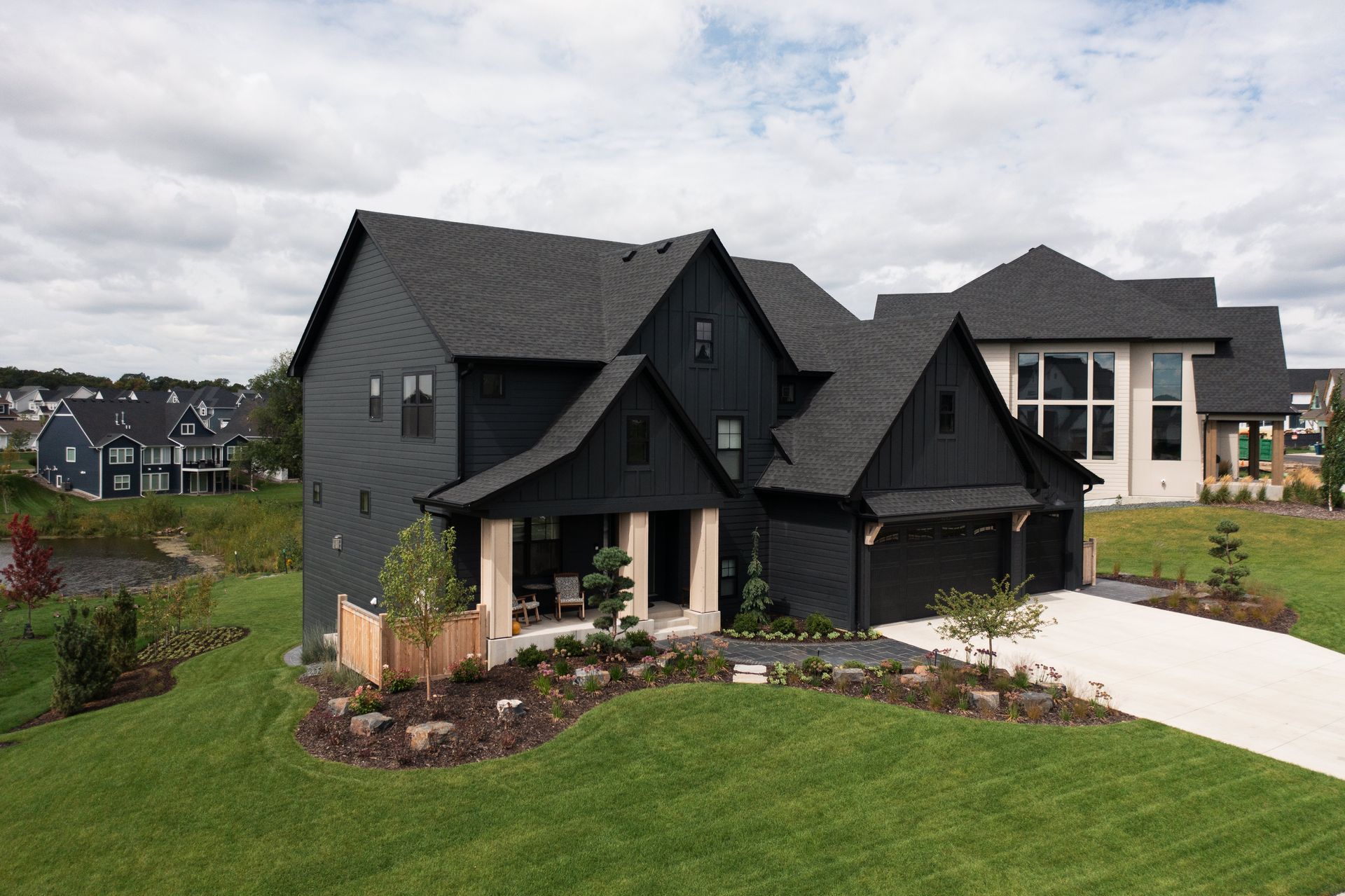 Aerial view of new front yard landscaping with curved beds, paver walkway, flowers, and specimen trees, Plymouth MN