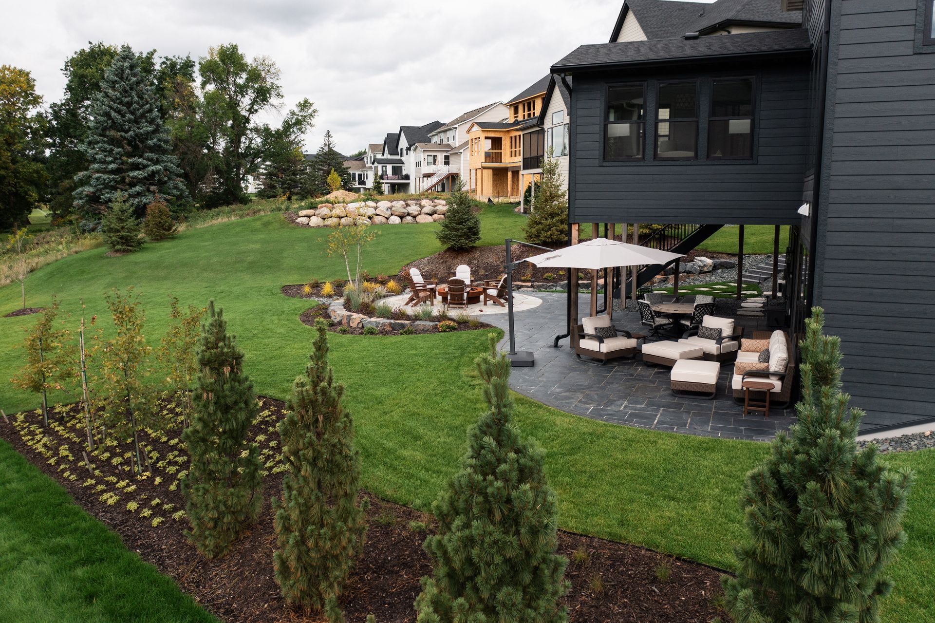Backyard patio and outdoor living space below deck and porch.