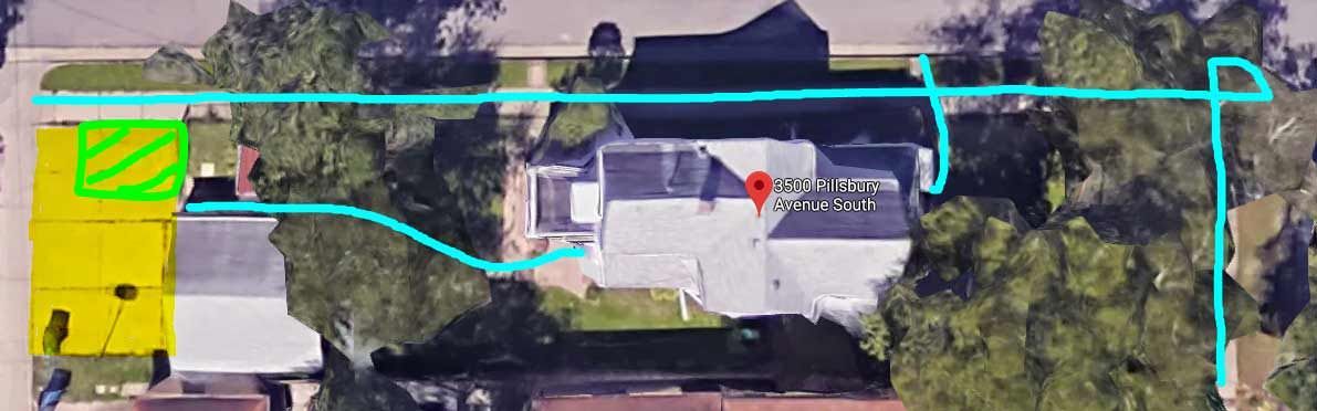 An aerial view of a house with a blue line between two houses.
