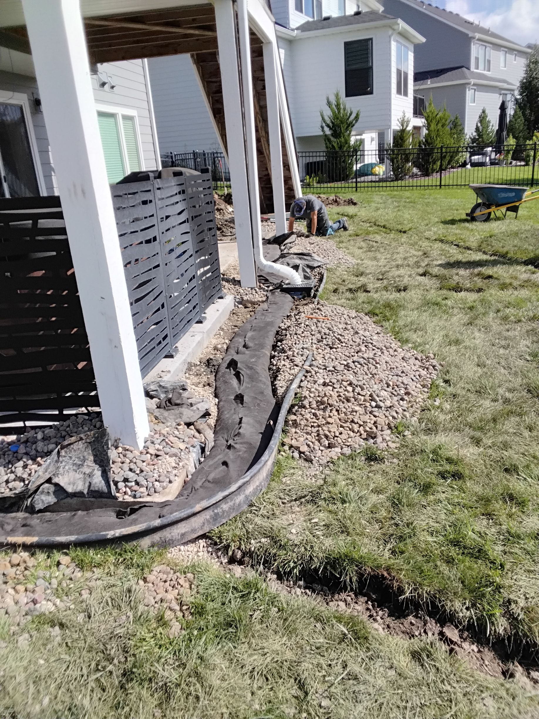 Our crew installing a French drain around a patio 