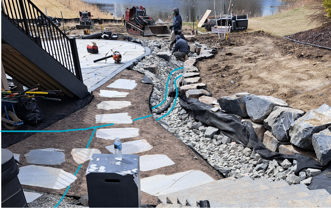 Blue line marks the underground pipe carrying sump discharge and a downspout downhill to a dry creek bed, Plymouth