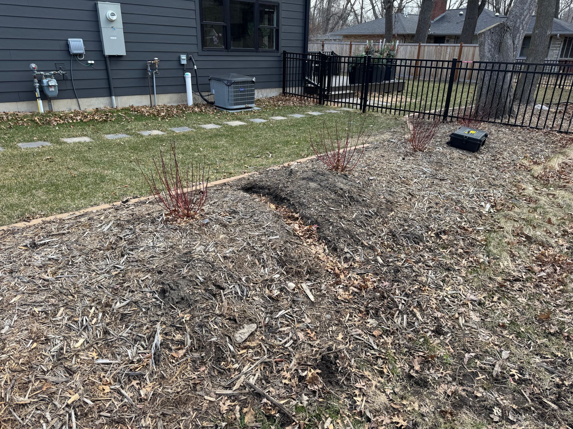 Before: Previous landscaping adjustments had compromised the efficacy of this swale, which no longercollected and drained rainwater as intended.