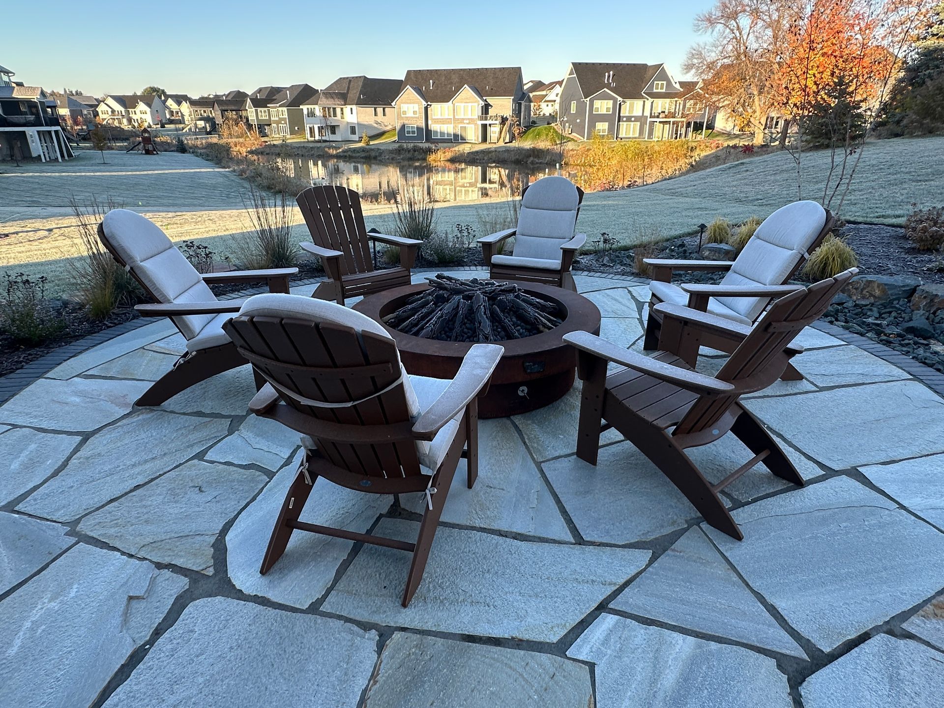 Flagstone fire pit conversation area in backyard