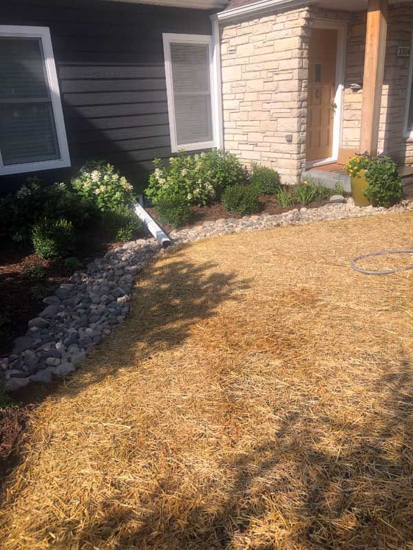 Front yard exposed / open French drain catching water running toward house the street in front is higher than the soil elevation at the house foundation) so this trench catches water running toward house and drains that water into the new dry well