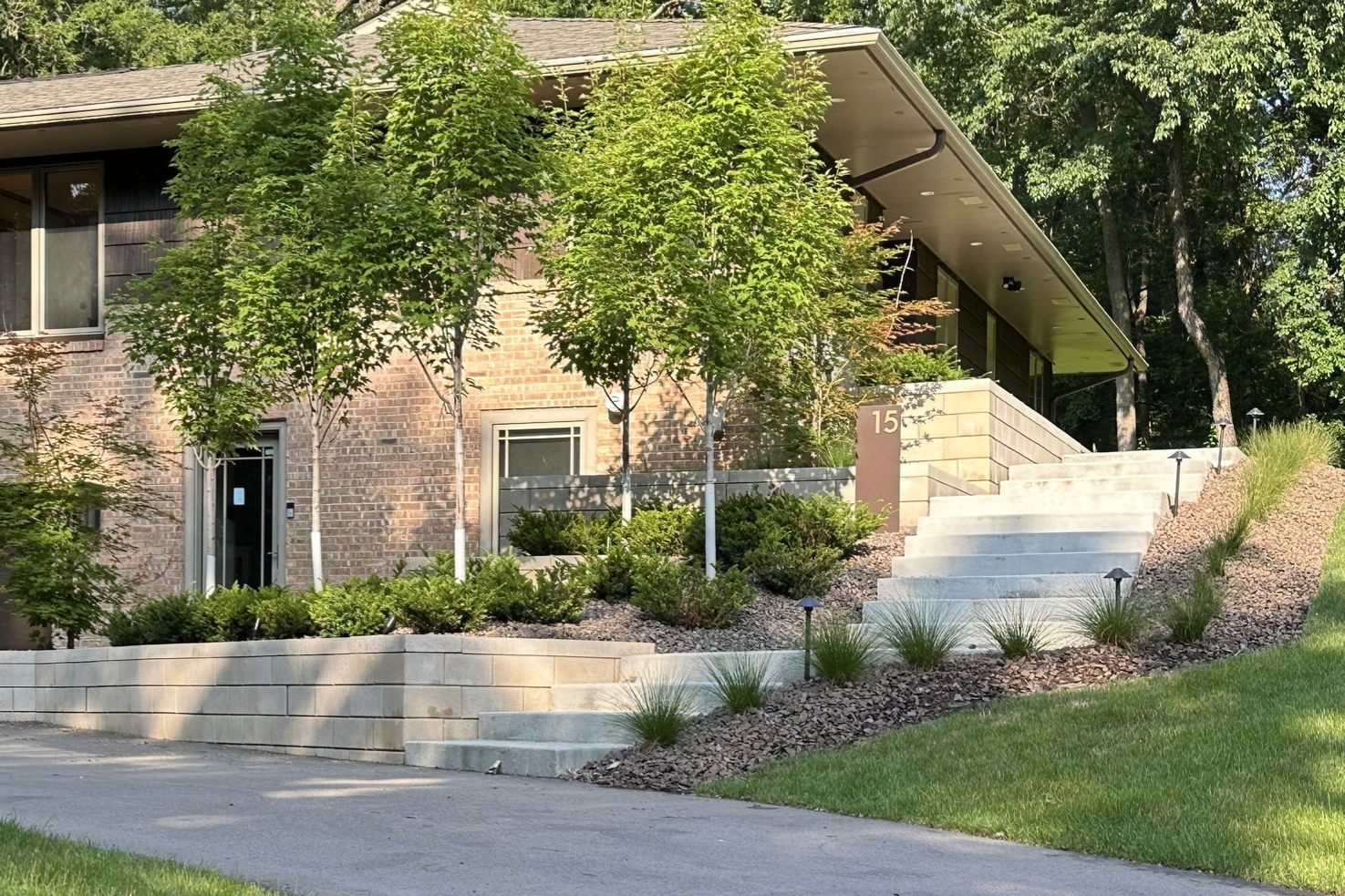 Mid-century modern front yard in Hopkins MN with custom steps, retaining wall, and plantings