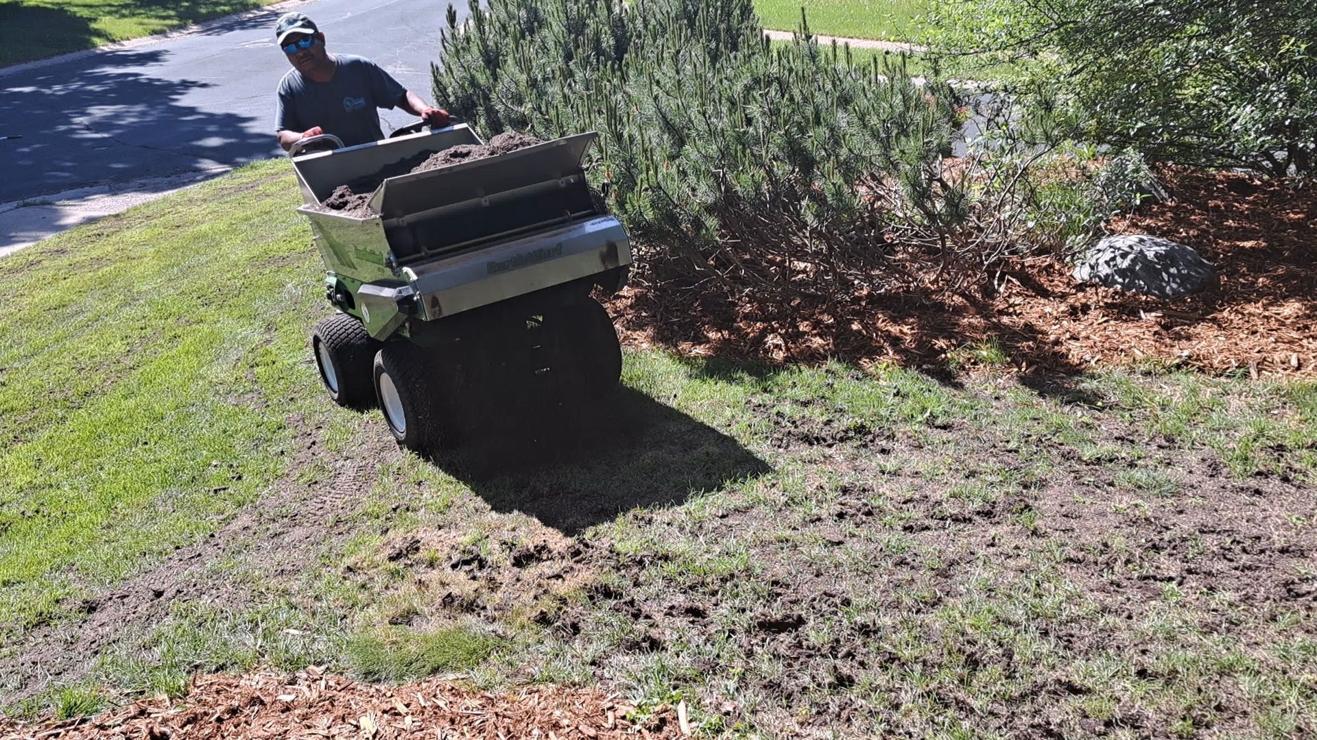 Providing topdressing to lawn in Minnesota.
