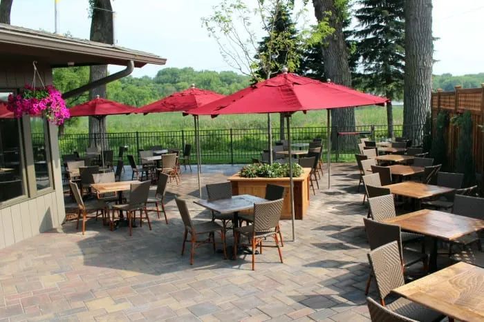Restaurant outdoor paver patio with customer cedar planter boxes with tree