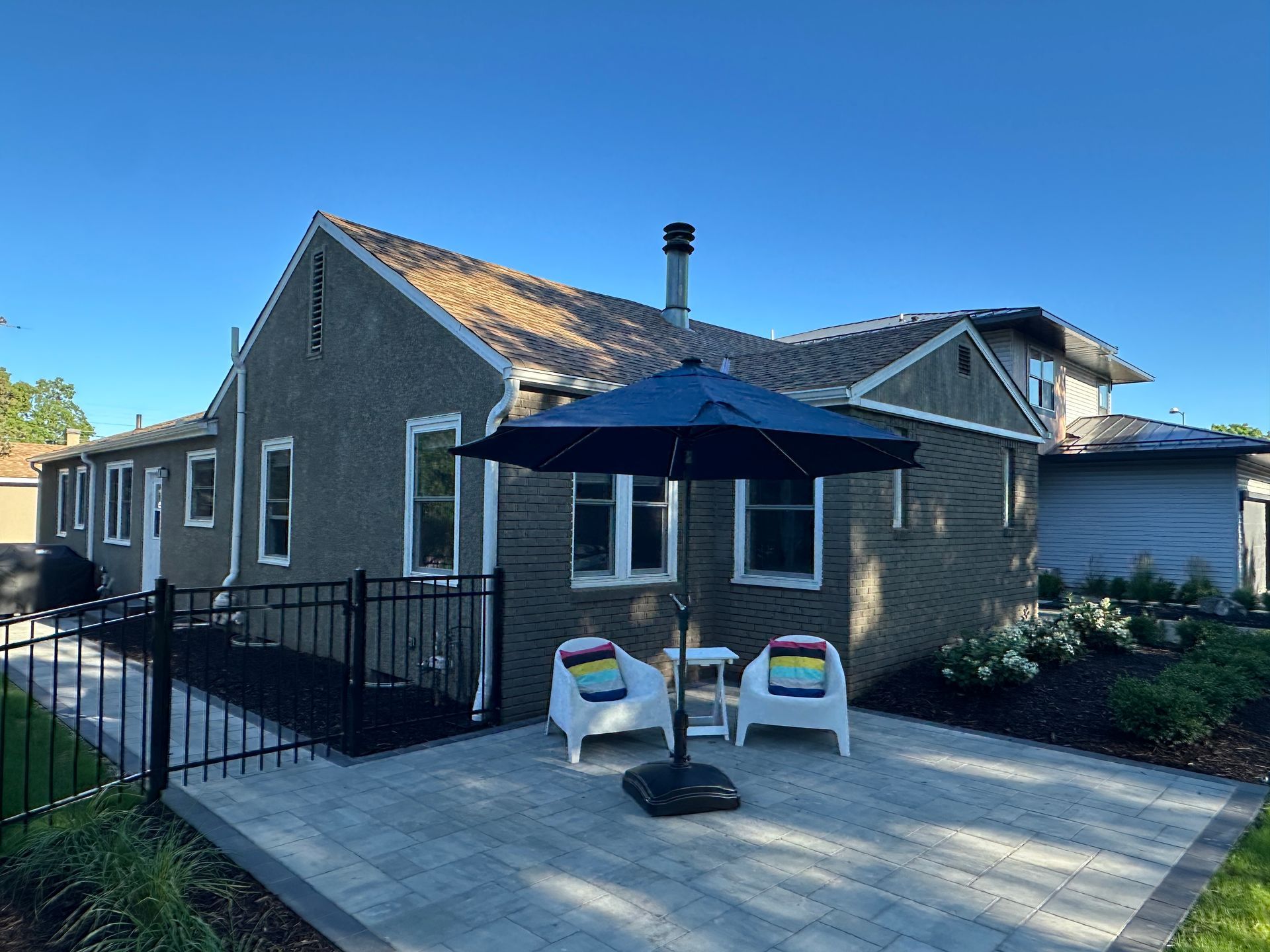 A new patio slots perfectly into the front yard for high curb appeal and neighborly visits.