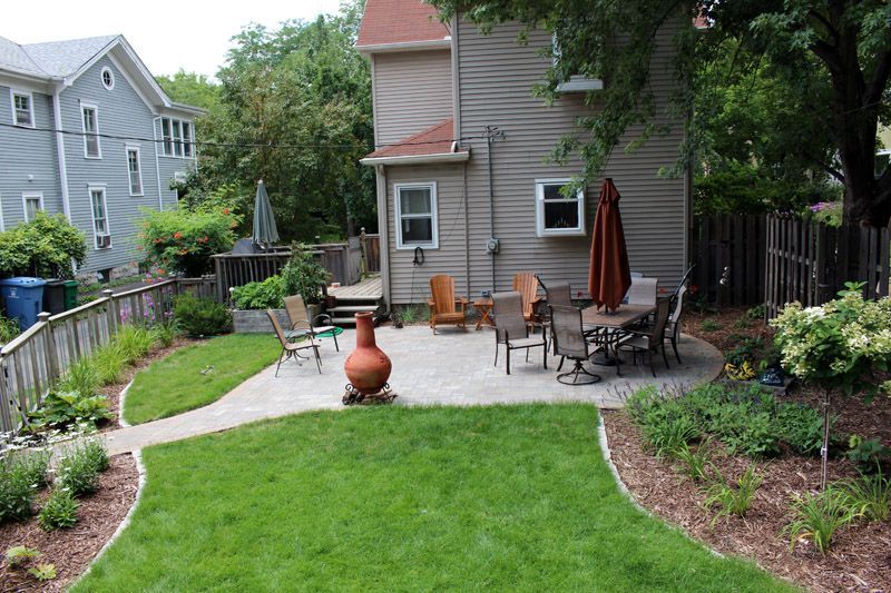The same Whittier backyard after the project, with new sod, a paver patio and planting beds