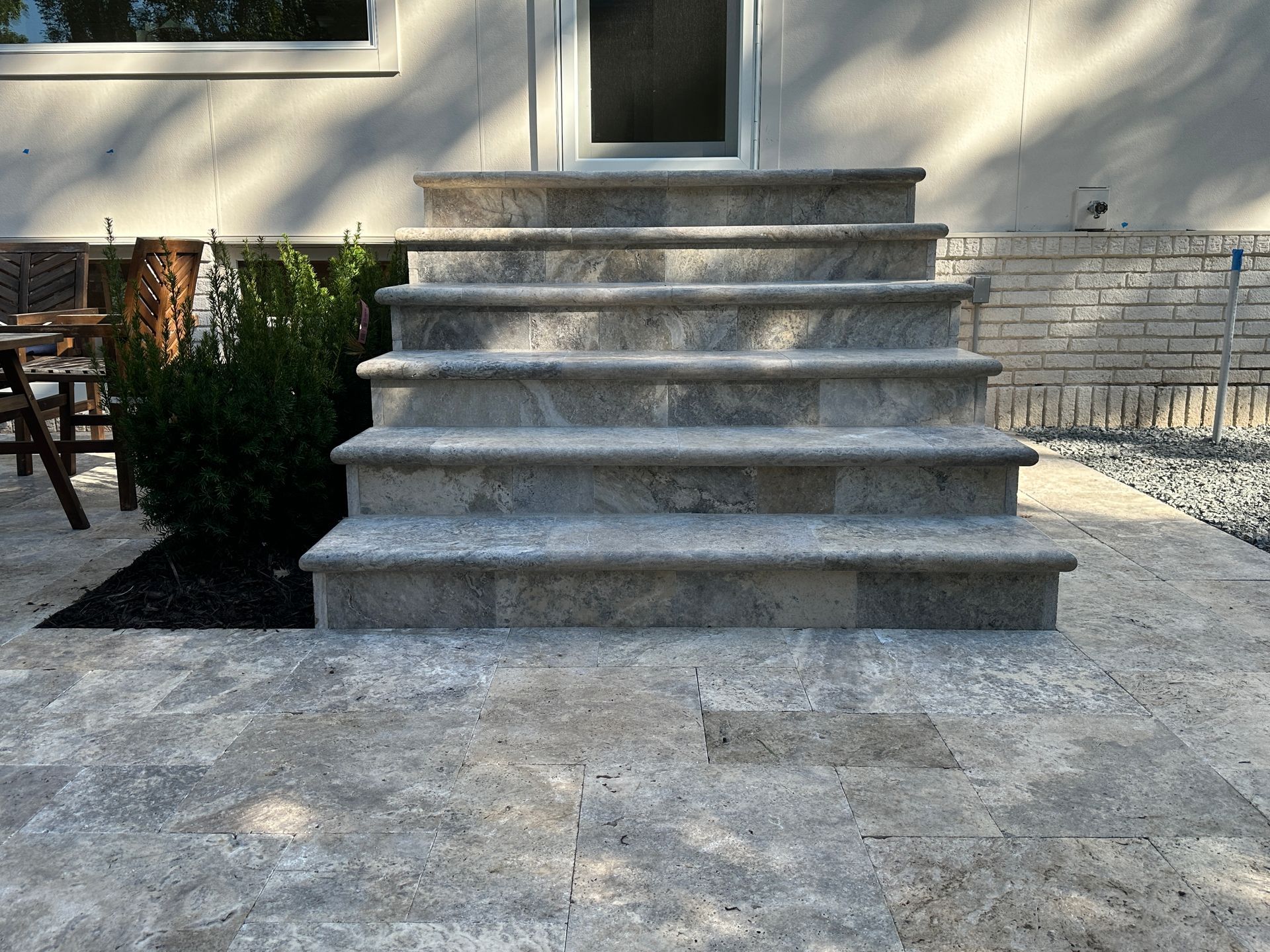 New customer natural stone faced patio door landing and step we did in Minneapolis project by KG Landscape 