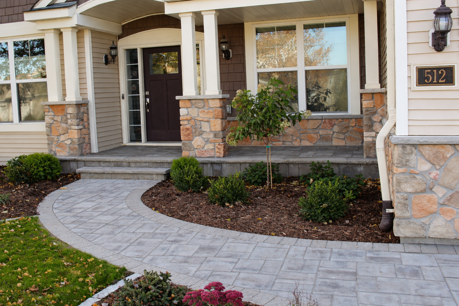 Concrete step and porch we faced with pavers and limestone treads coping in Blaine MN project by KG Landscape