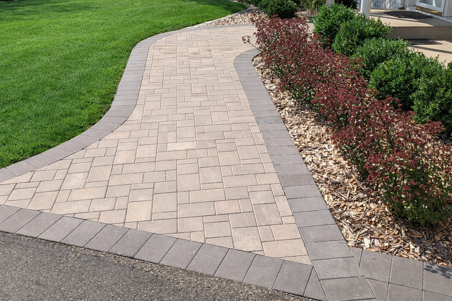 New front entry paver pathway with boxwoods shrubs and sedum flowers in Edina MN