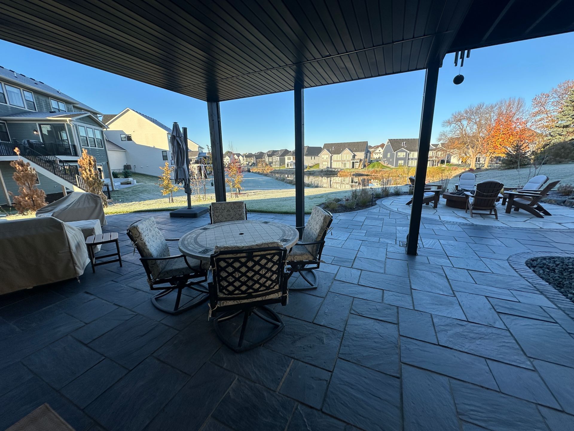 Patio below three season porch made of black flagstone