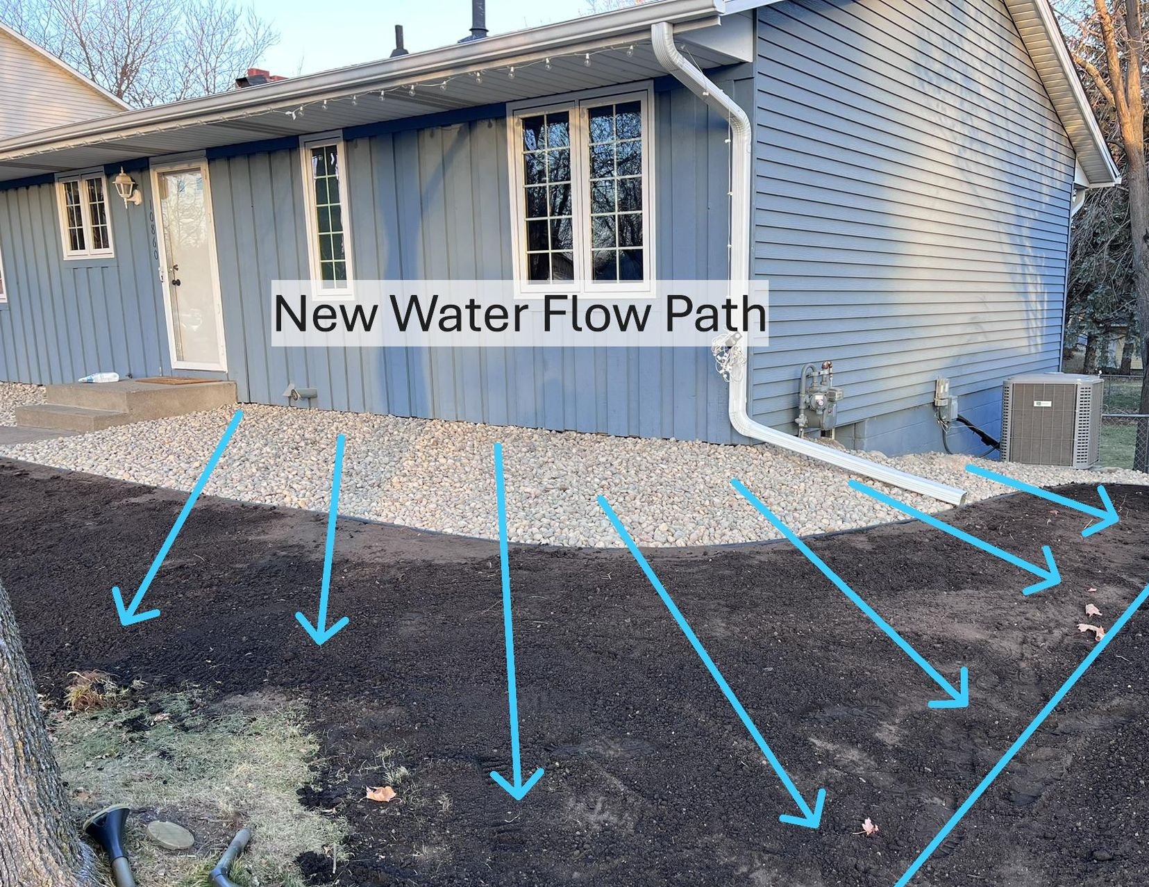 New foundation grading in Minneapolis with poly liner, rock, and edging, sloped so water runs away from the house